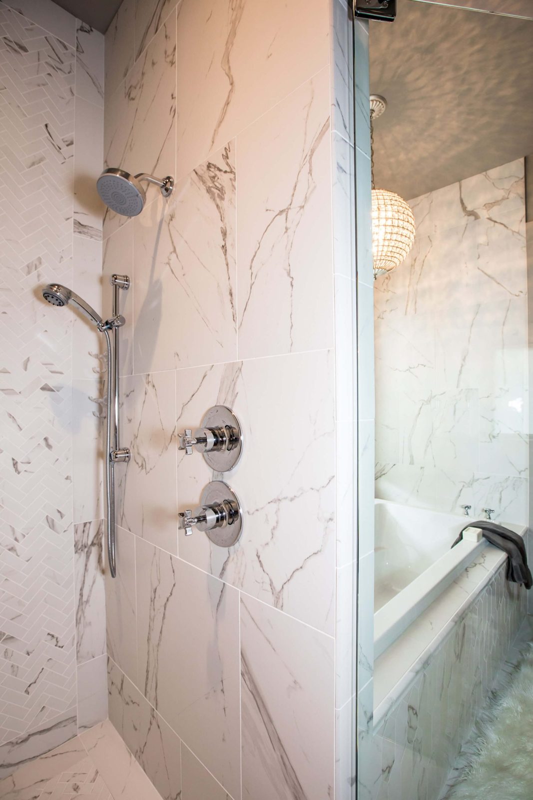 Marble-tile shower and soaking-tub surround remodeled by I&E Renovations